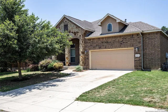 a front view of a house with a yard and garage