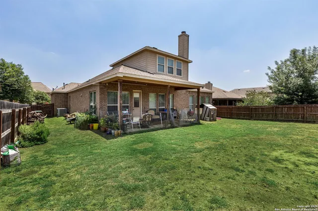 a view of a house with backyard porch and garden