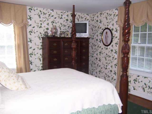 3419 Leonard Street Raleigh, NC 27607 - Photo 6 of 10 a bedroom with a bed and cabinets