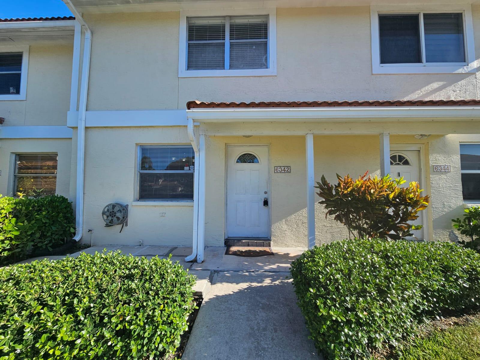 6342 Walk Circle Boca Raton, FL 33433 - Photo 1 of 10 a front view of a house with a yard