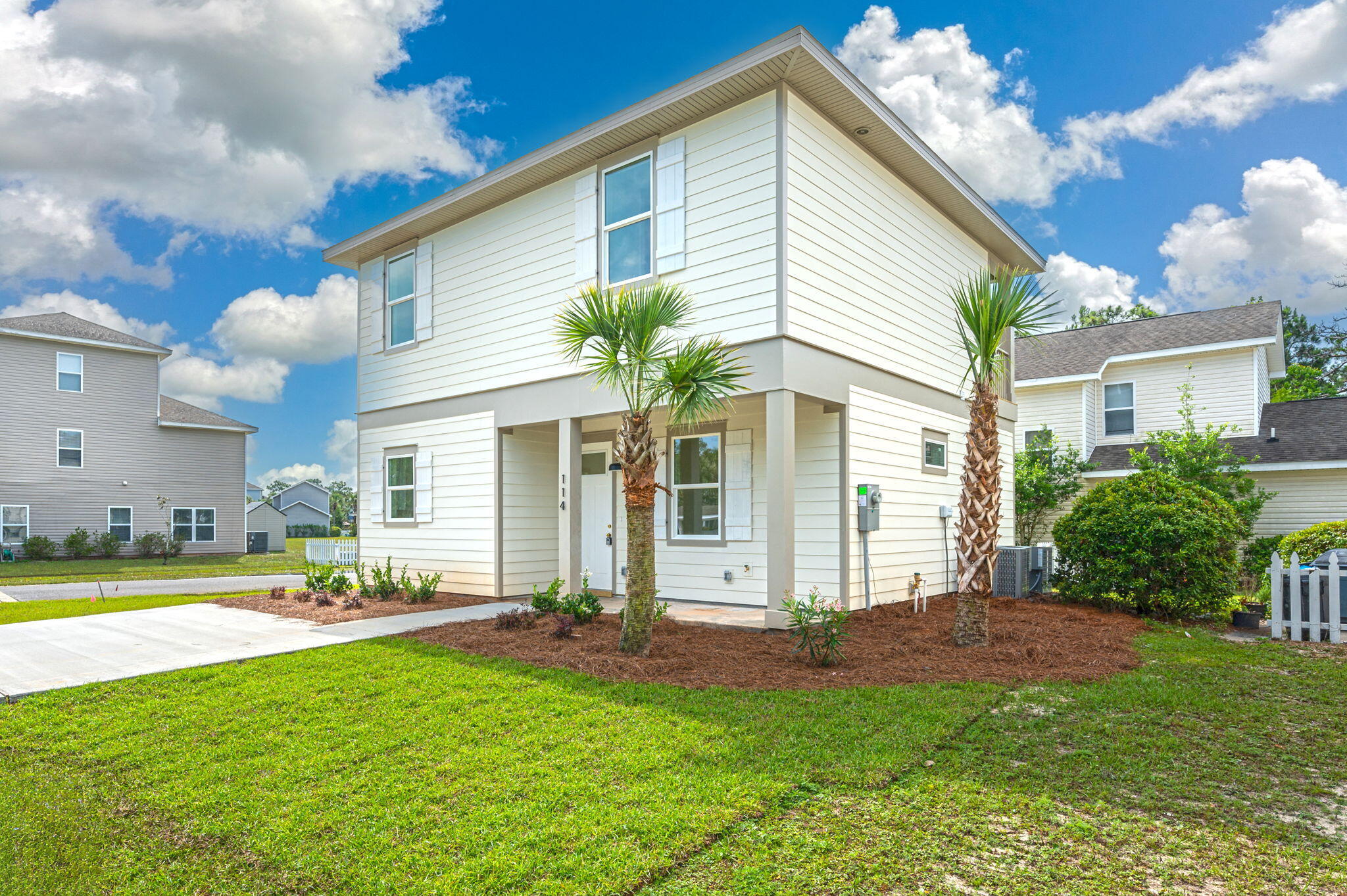 a view of a house with backyard and sitting area