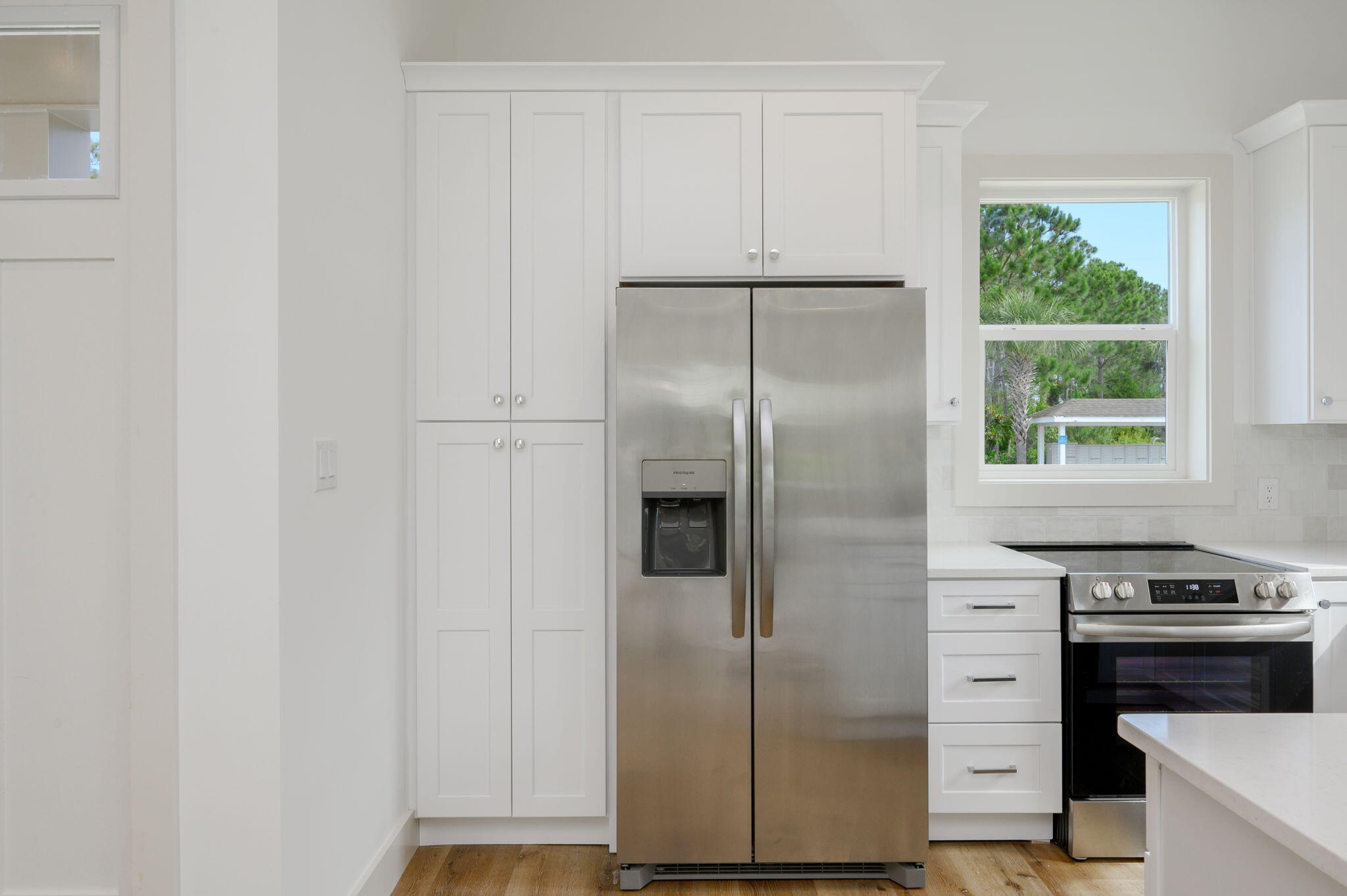 114 Enchanted Way Santa Rosa Beach, FL 32459 - Photo 18 of 38 a kitchen with a refrigerator and a stove top oven