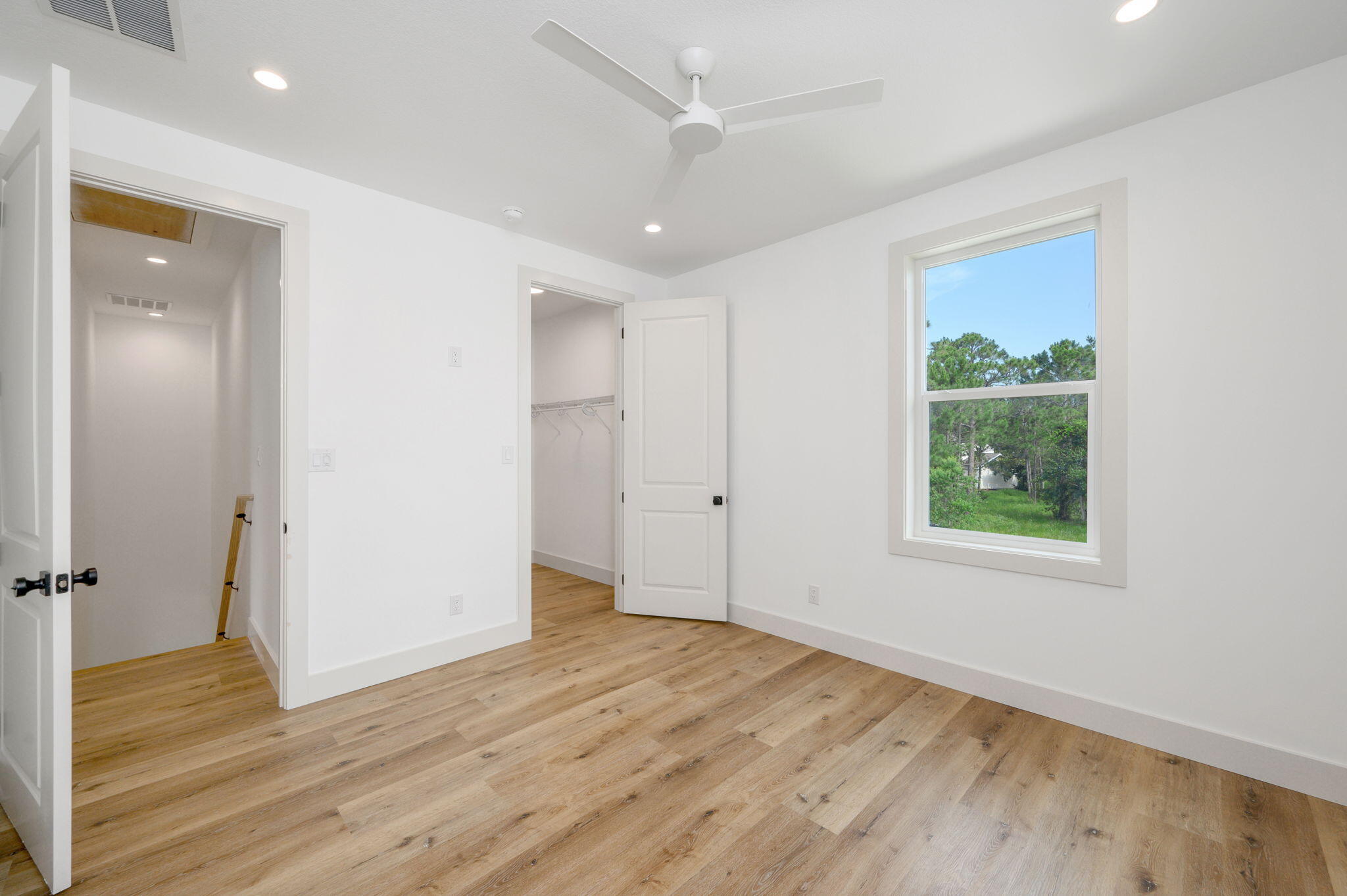 114 Enchanted Way Santa Rosa Beach, FL 32459 - Photo 29 of 38 an empty room with wooden floor and windows
