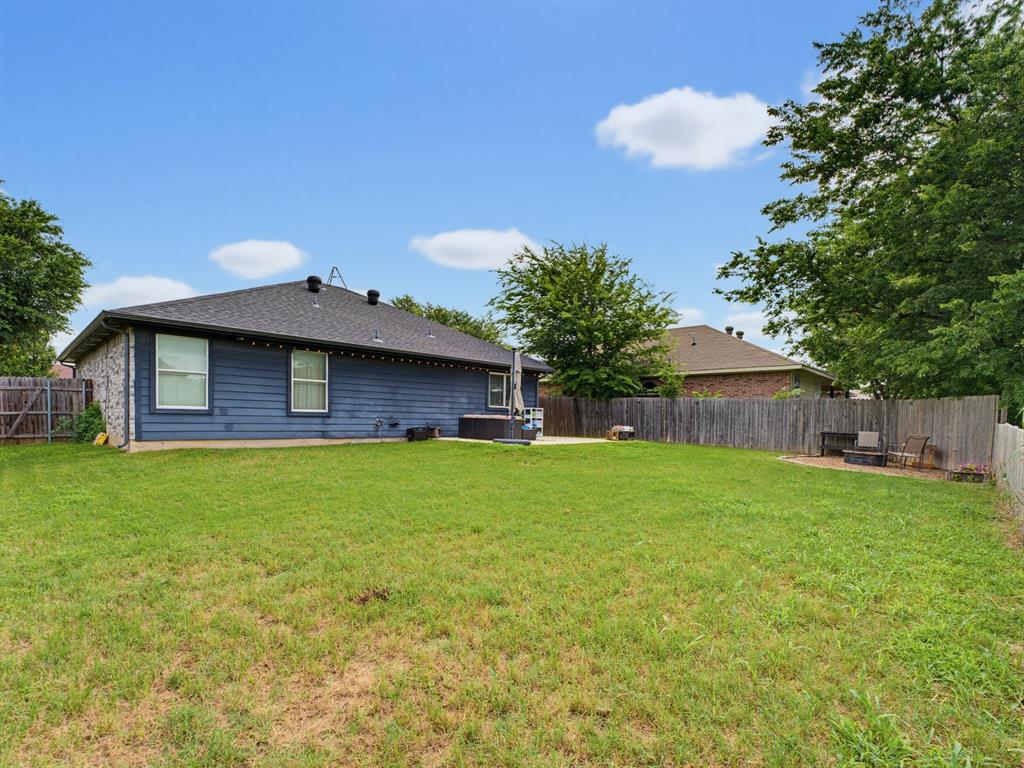 600 Stirling Road Rhome, TX 76078 - Photo 37 of 38 Expansive green lawn with a privacy fence