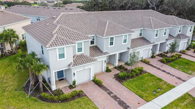 a aerial view of a house with a yard and potted plants