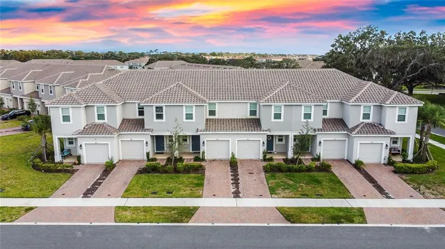 an aerial view of a house with garden space and lake view