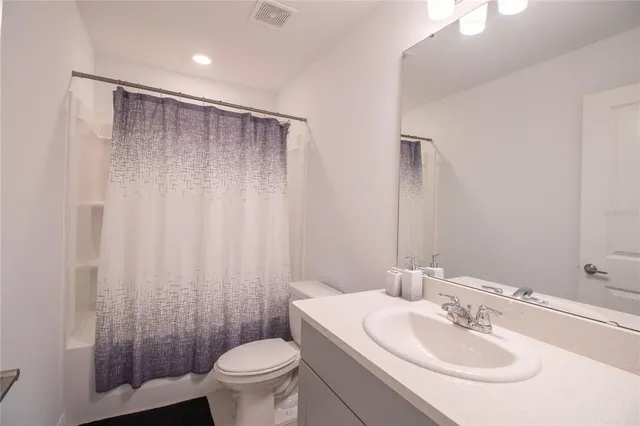 a bathroom with a sink toilet and a mirror