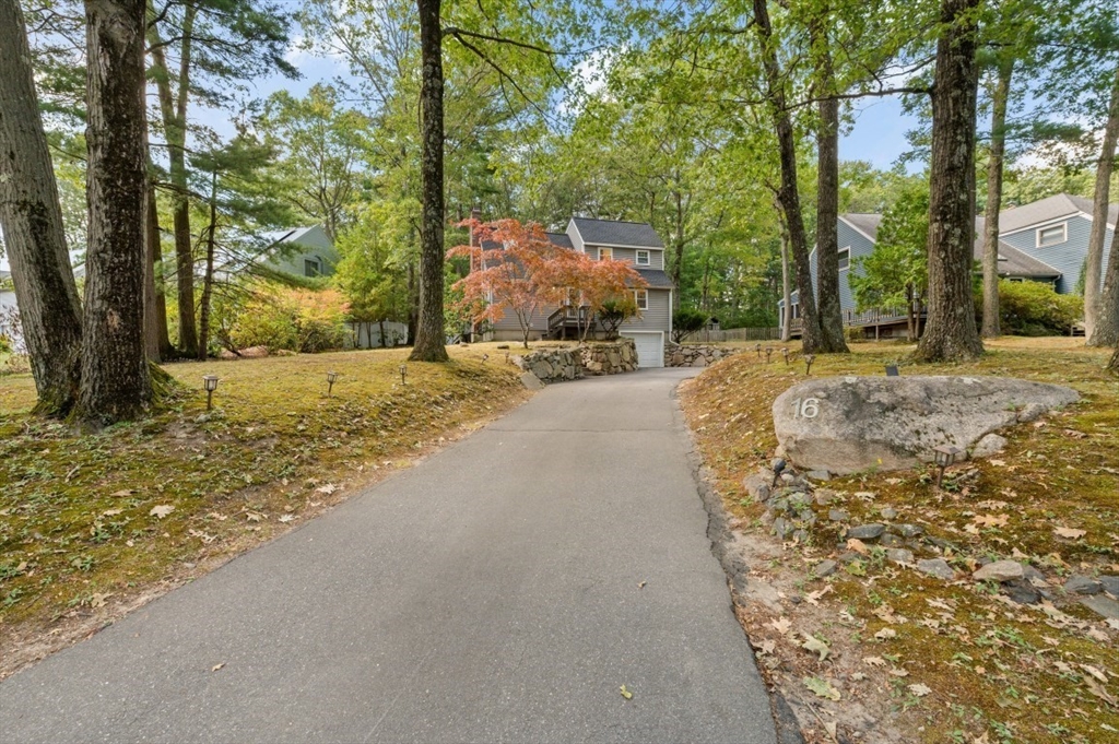 16 Sherborne Circle Ashland, MA 01721 - Photo 1 of 35 a view of a backyard with large trees