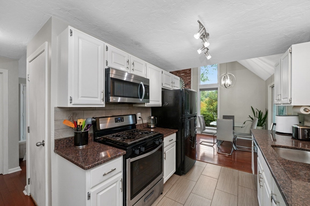 16 Sherborne Circle Ashland, MA 01721 - Photo 14 of 35 a kitchen with stainless steel appliances granite countertop a sink stove and refrigerator
