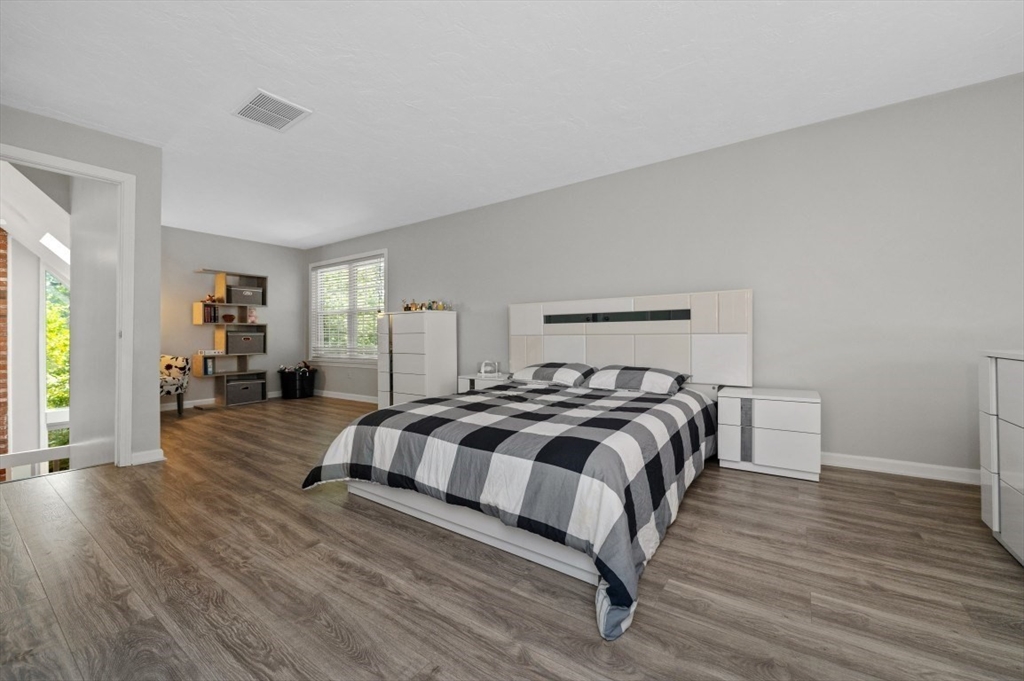 16 Sherborne Circle Ashland, MA 01721 - Photo 20 of 35 a bedroom with a bed and wooden floor