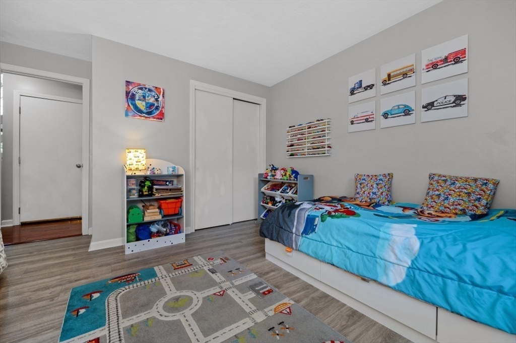 16 Sherborne Circle Ashland, MA 01721 - Photo 24 of 35 a bedroom with furniture and a book shelf