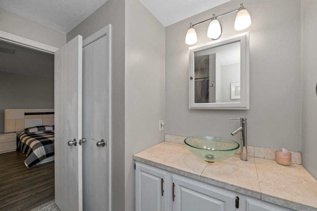 16 Sherborne Circle Ashland, MA 01721 - Photo 27 of 35 a en suite bathroom with a granite countertop sink and a mirror