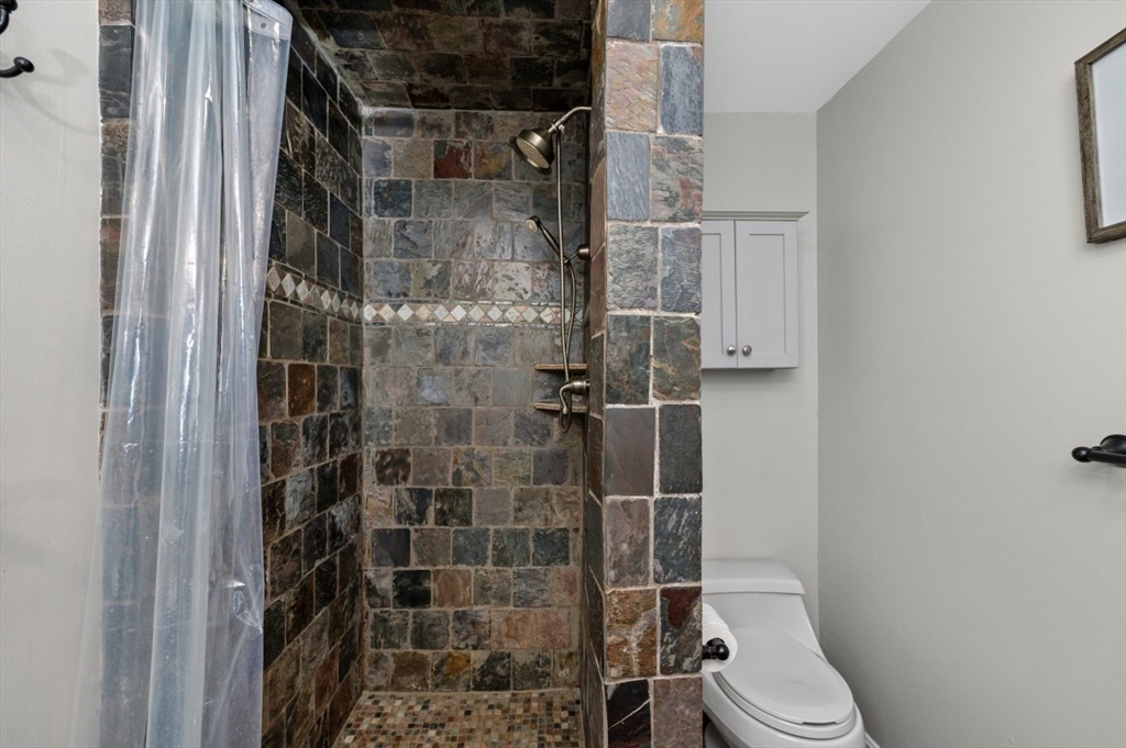 16 Sherborne Circle Ashland, MA 01721 - Photo 28 of 35 a bathroom with a toilet and shower