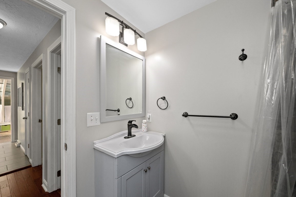 16 Sherborne Circle Ashland, MA 01721 - Photo 32 of 35 a bathroom with a sink and mirror