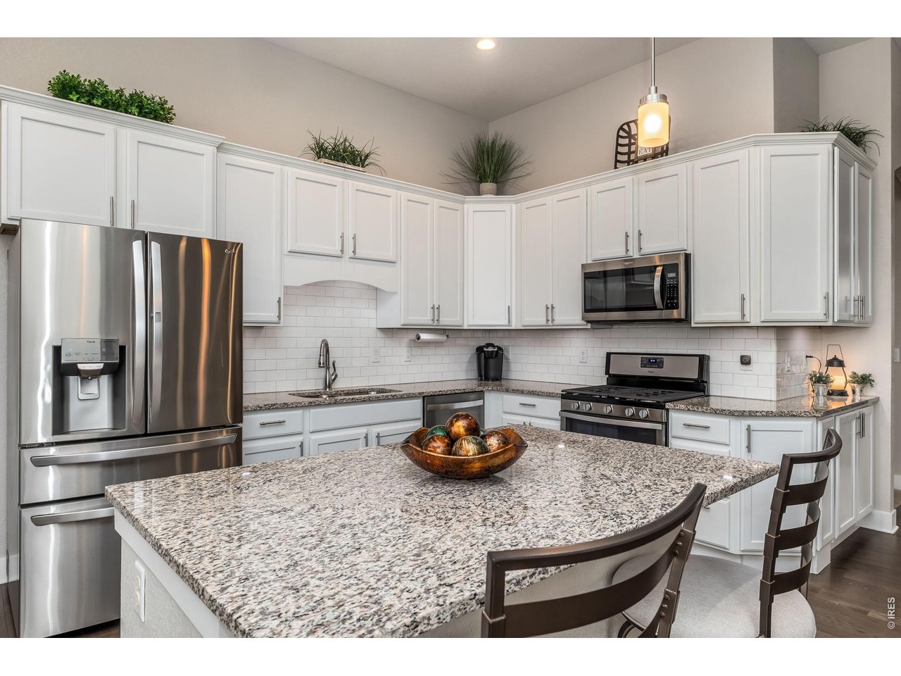 3789 Bridle Ridge Circle Severance, CO 80524 - Photo 15 of 44 a kitchen with stainless steel appliances granite countertop a sink refrigerator and microwave