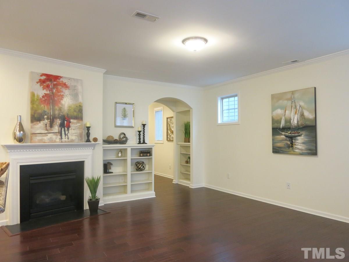 1556 Rodessa Run Raleigh, NC 27607 - Photo 4 of 25 The spacious Living Rm offers a gas log FP, built-in bookcase & lots of windows.