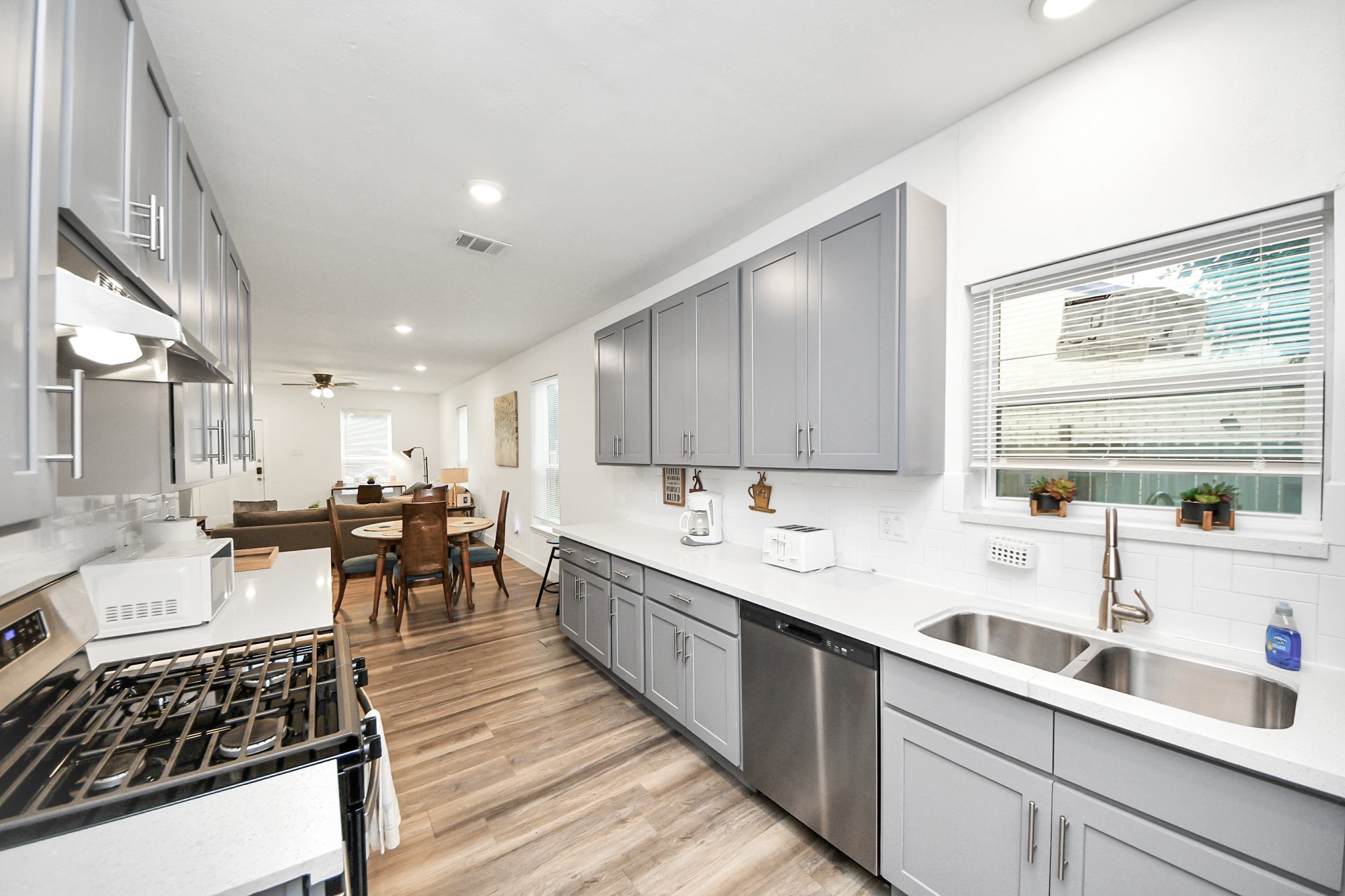 6917 Rook Boulevard Houston, TX 77087 - Photo 11 of 32 a kitchen with lots of counter top space and wooden floor