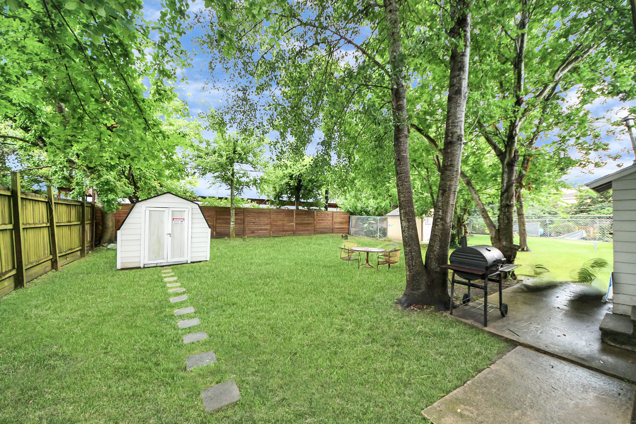6917 Rook Boulevard Houston, TX 77087 - Photo 13 of 32 a view of a garden with a slide and a bench