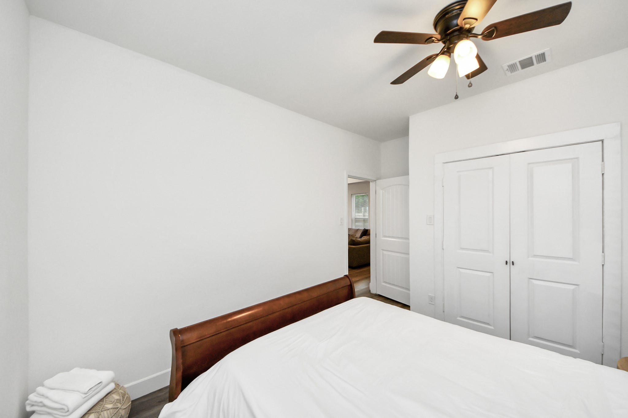 6917 Rook Boulevard Houston, TX 77087 - Photo 27 of 32 a bedroom with a bed and a chandelier fan