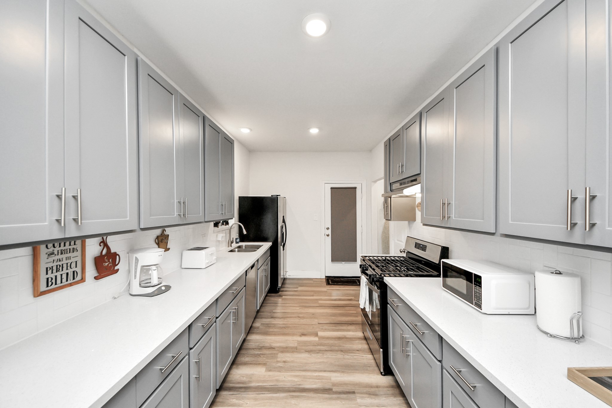 6917 Rook Boulevard Houston, TX 77087 - Photo 10 of 32 a kitchen with a sink stove and cabinets