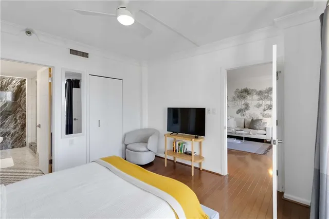 a bedroom with a bed and a flat screen tv