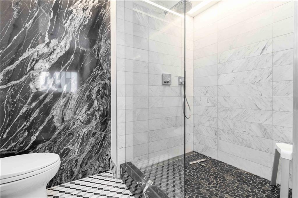 1130 Piedmont Avenue Northeast, Unit 1109 Atlanta, GA 30309 - Photo 15 of 40 a bathroom with a toilet and a shower