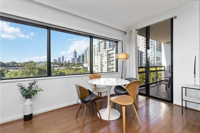 a dining room with furniture window and wooden floor