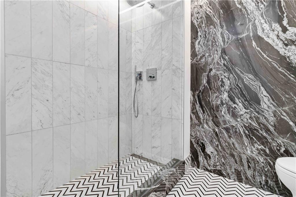 1130 Piedmont Avenue Northeast, Unit 1109 Atlanta, GA 30309 - Photo 19 of 40 a bathroom with a toilet and shower