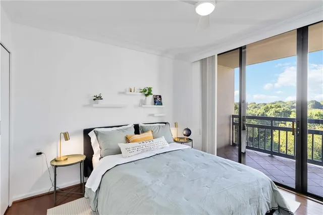 a bedroom with a bed and glass window