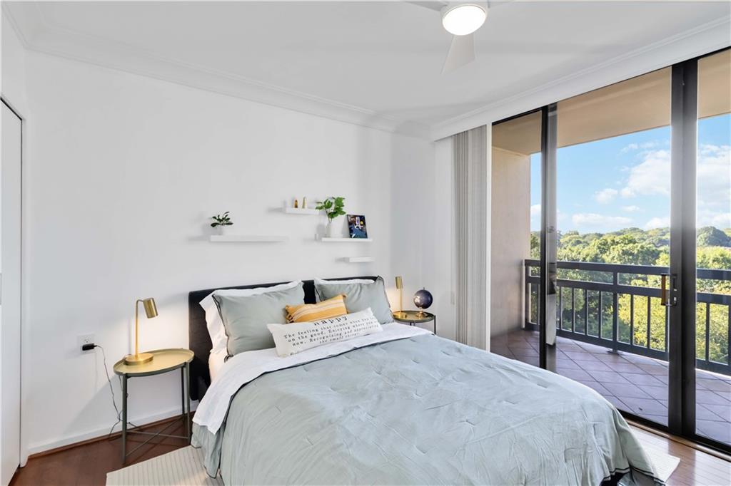 1130 Piedmont Avenue Northeast, Unit 1109 Atlanta, GA 30309 - Photo 20 of 40 a bedroom with a bed and glass window