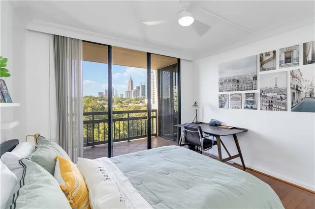 a bedroom with a bed and a large window