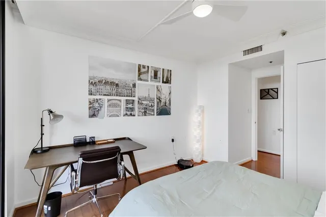 a bedroom with a bed and a desk