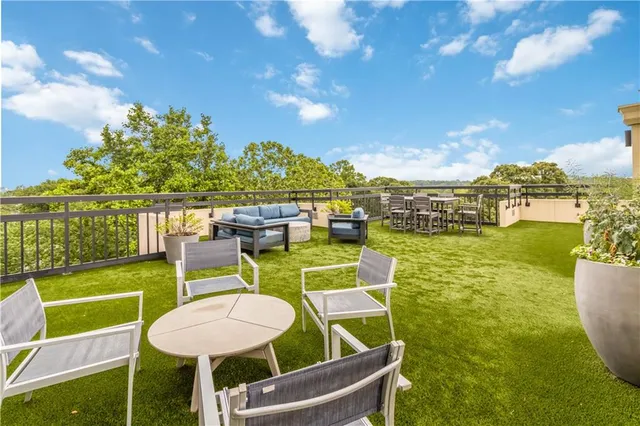 a view of a house with swimming pool and sitting area