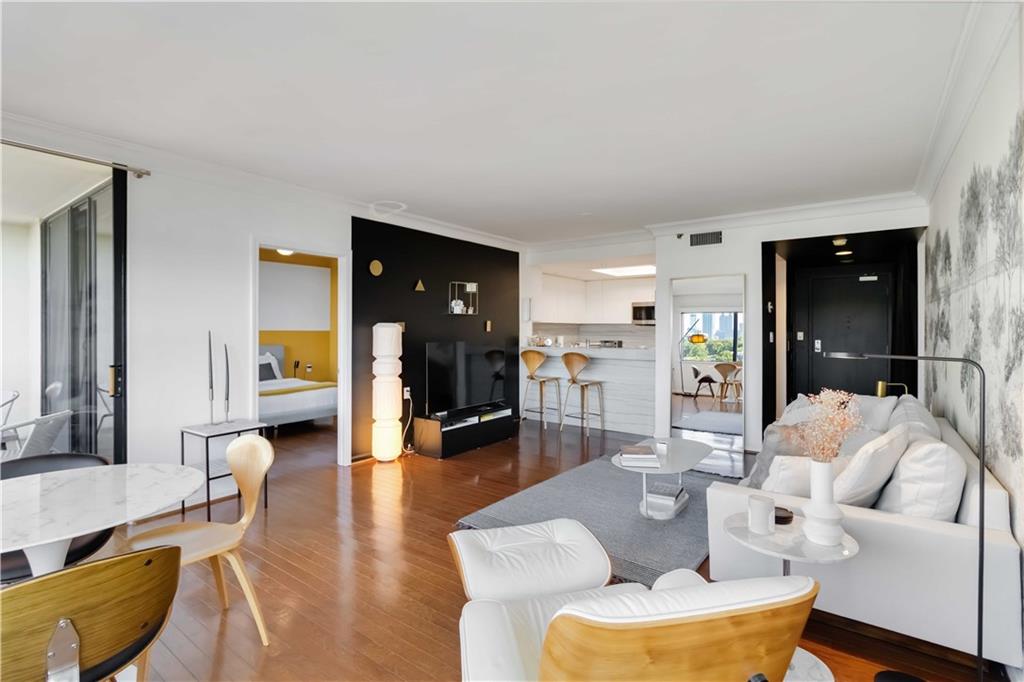 1130 Piedmont Avenue Northeast, Unit 1109 Atlanta, GA 30309 - Photo 6 of 40 a living room with furniture and a wooden floor