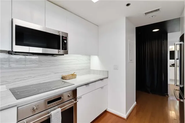 a kitchen with a stove and a microwave