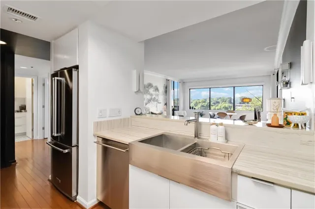 a kitchen with kitchen island a counter top space a sink stove and refrigerator