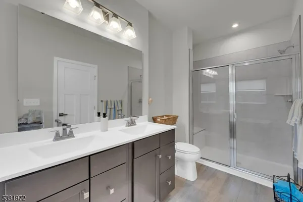 a bathroom with a sink double vanity and a shower