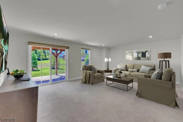 a living room with furniture and large windows