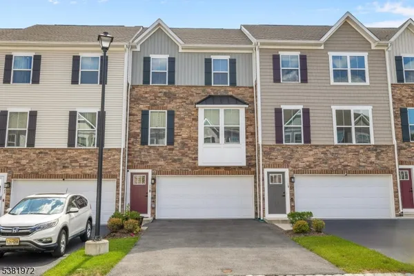 a front view of a house with parking space