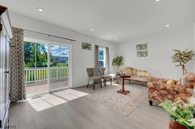 a living room with furniture and a floor to ceiling window