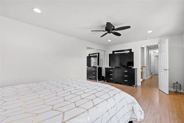 a bed room with a bed television and a large window