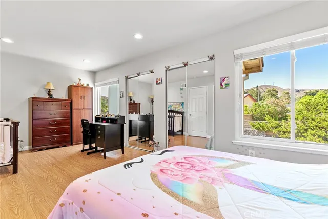 a bedroom with a bed dresser and window