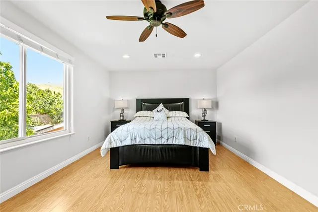 a bathroom with a granite countertop sink a toilet a mirror and shower