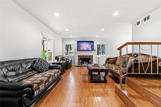 a living room with furniture a fireplace and a flat screen tv