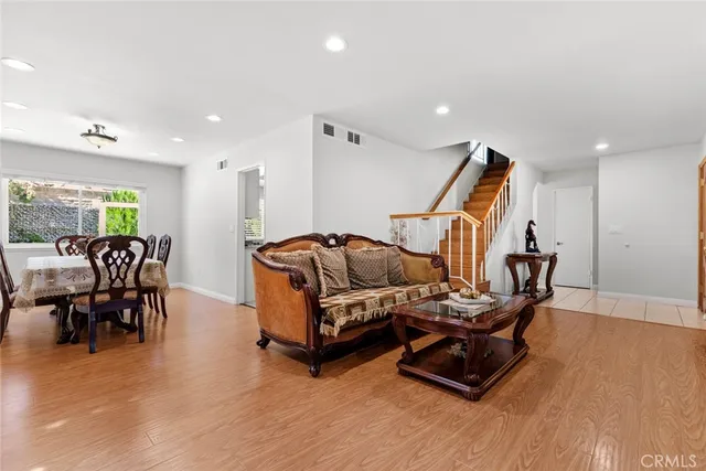 a view of an entryway with wooden floor and staircase