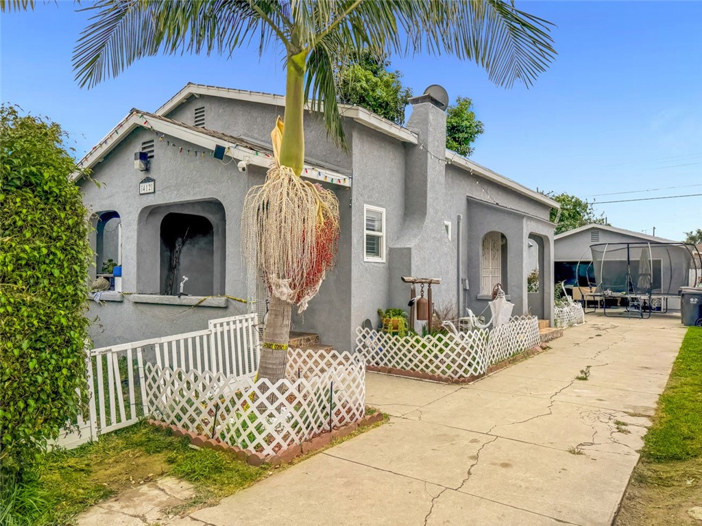 412 West Pear Street Compton, CA 90222 - Photo 1 of 19 a front view of a house with garden