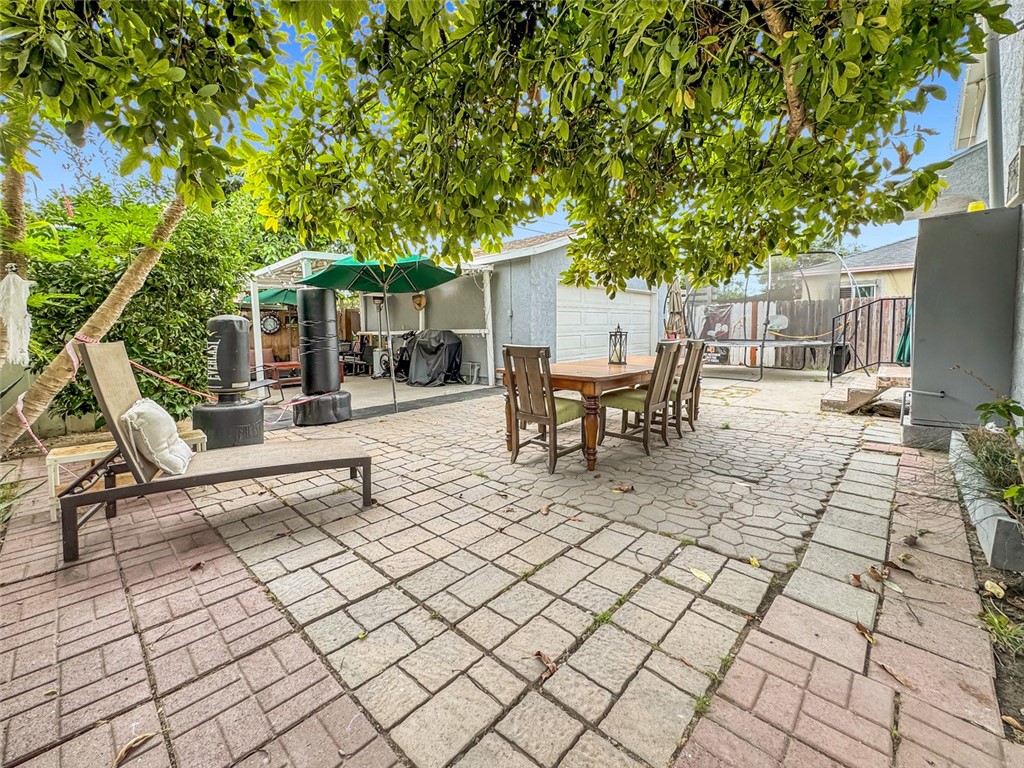 412 West Pear Street Compton, CA 90222 - Photo 18 of 19 a patio with table and chairs and potted plants