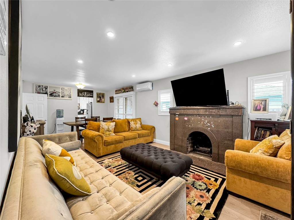412 West Pear Street Compton, CA 90222 - Photo 6 of 19 a living room with furniture a fireplace and a flat screen tv