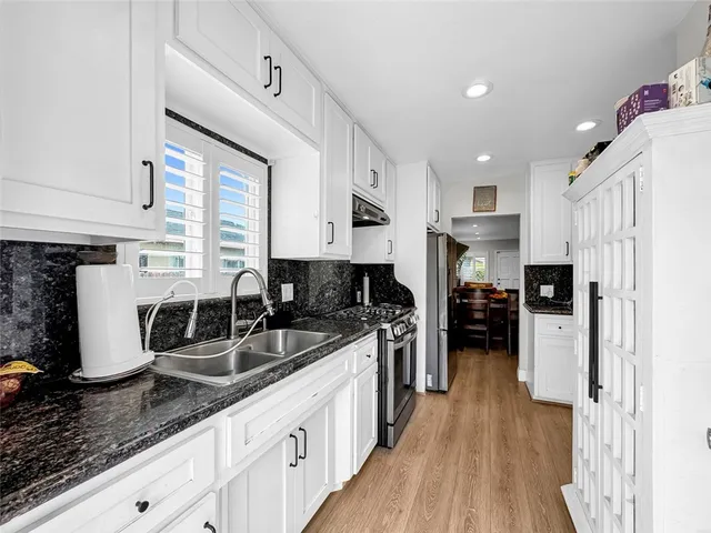 a kitchen with refrigerator and cabinets