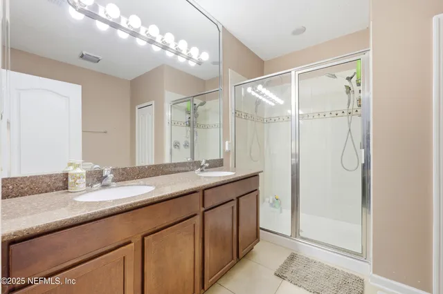 a bathroom with a double vanity sink mirror and double